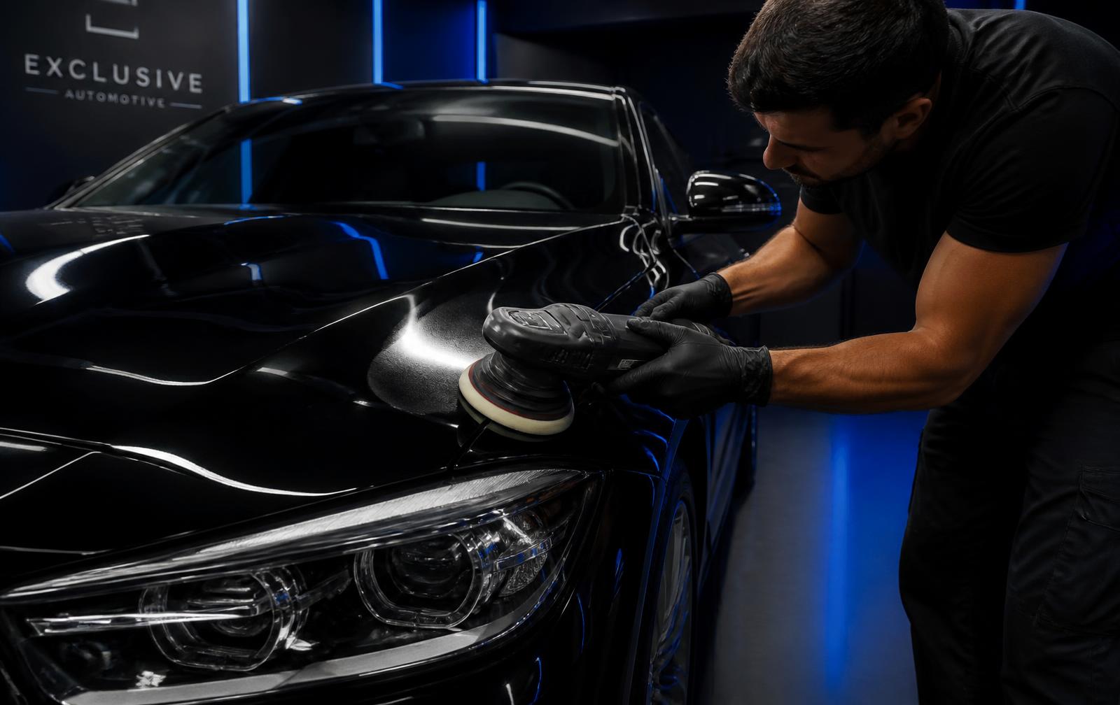 Profissional da Speedy realizando polimento automotivo na pintura de um carro escuro